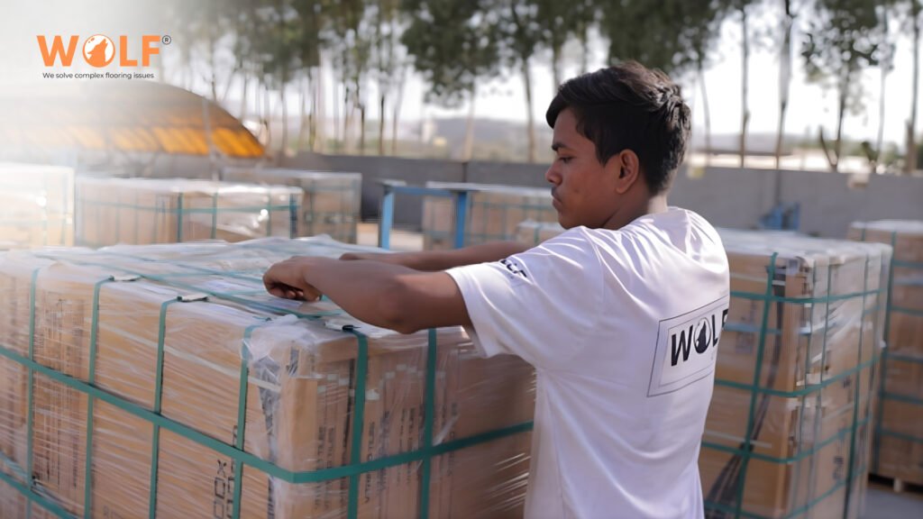 Wolf Group India worker wrapping palletized porcelain tiles with protective packaging for export shipment to Bulgaria