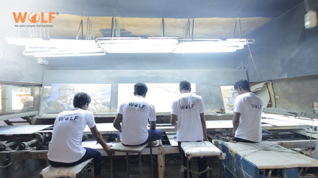 Workers monitoring porcelain tile production on a modern Indian factory line.