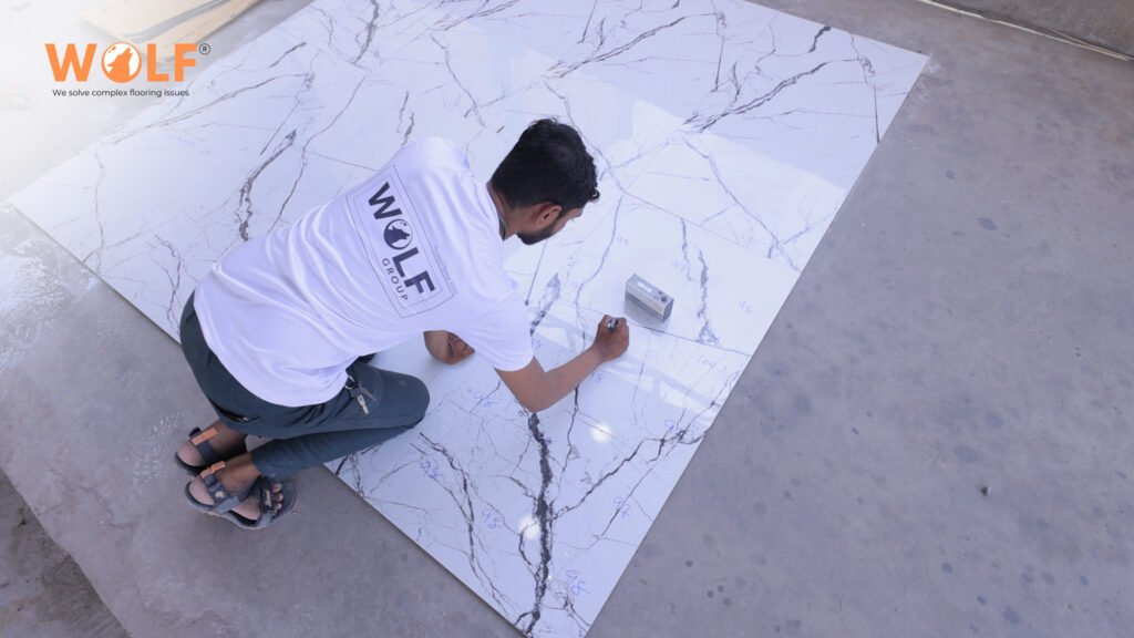 Technician measuring porcelain tile quality and surface consistency.