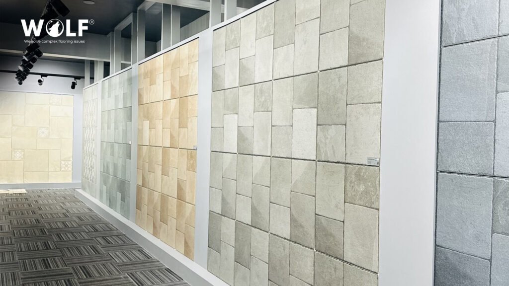 Large-format porcelain tiles in cream, light grey and beige displayed in tall panels at Wolf's showroom