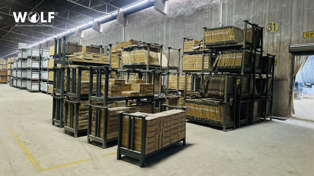 Packed porcelain tile cartons in numbered steel racks at Wolf's warehouse in Morbi, ready for dispatch