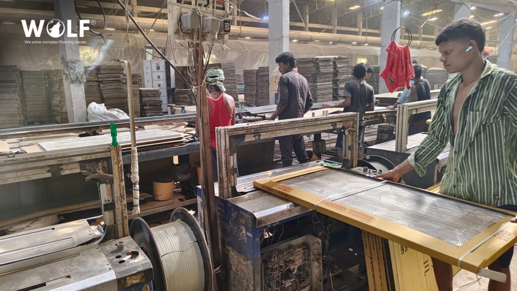 Worker packing porcelain tiles into cartons at Wolf’s Morbi factory, the packing step behind a 20ft container load