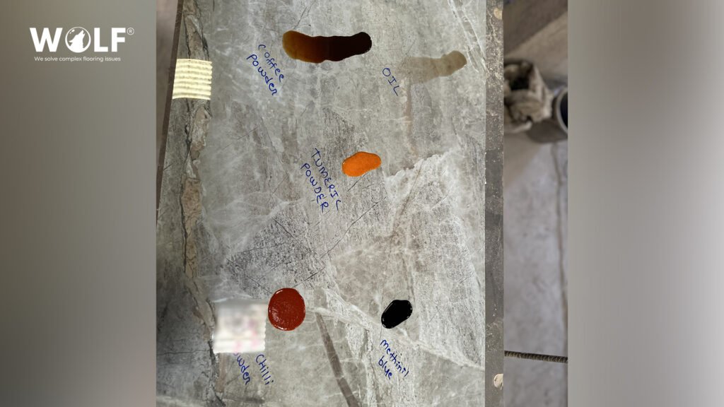 Porcelain tile surface with coffee, oil, turmeric, chilli and methylene blue stains for a commercial kitchen stain check