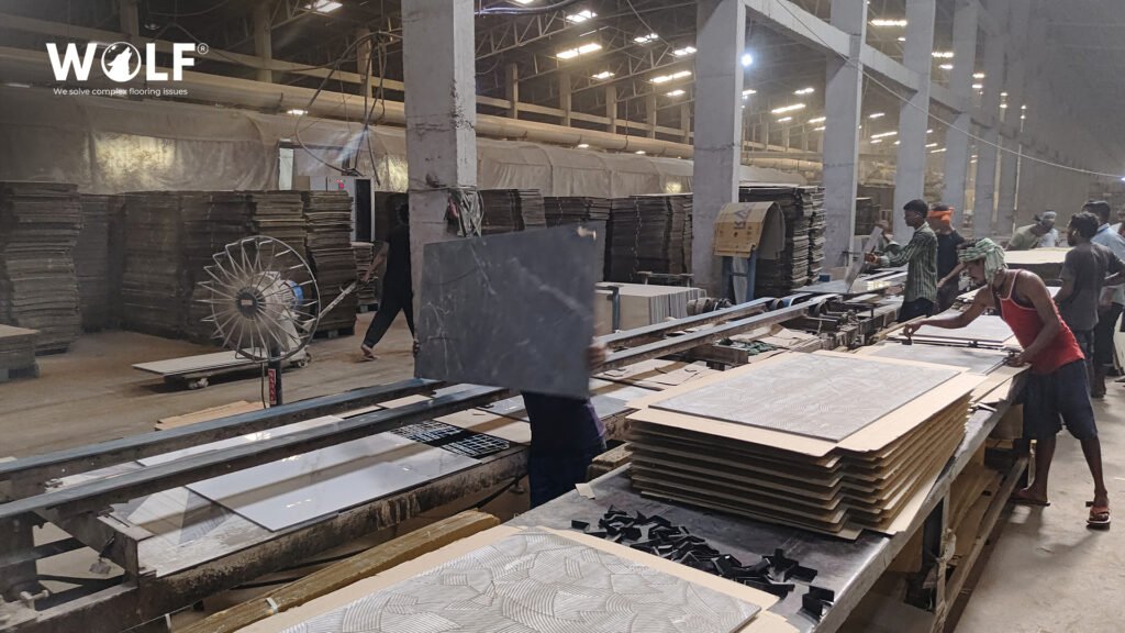 Workers sorting and packing finished porcelain tiles on a Wolf production line before loading a 20ft container